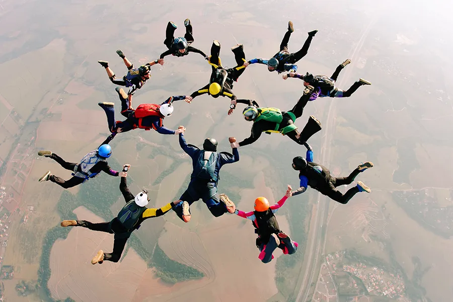Team of skydivers making formation
